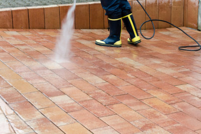 Worker is cleaning the terrace with high-pressure.