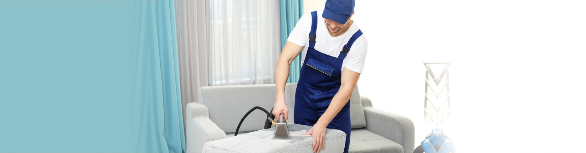 Dry cleaner's employee removing dirt from furniture in flat